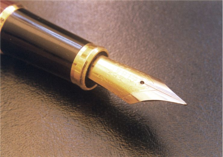 Picture Of Quill Pen Over A Leather Notepad